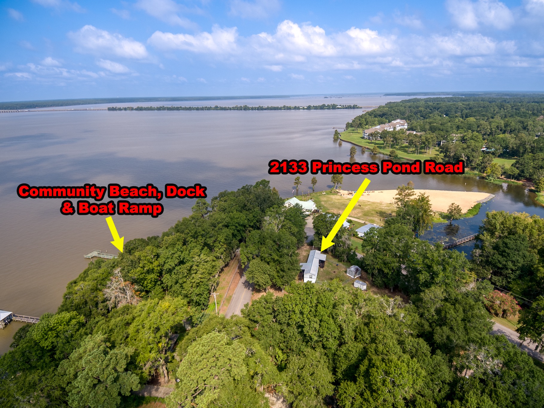 Aerial view of 2133 Princess Pond Road near the community beach, dock and boat ramp